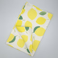 Folded Amalfi lemon towel with lemon pattern on a gray background from Hem And Tassel 