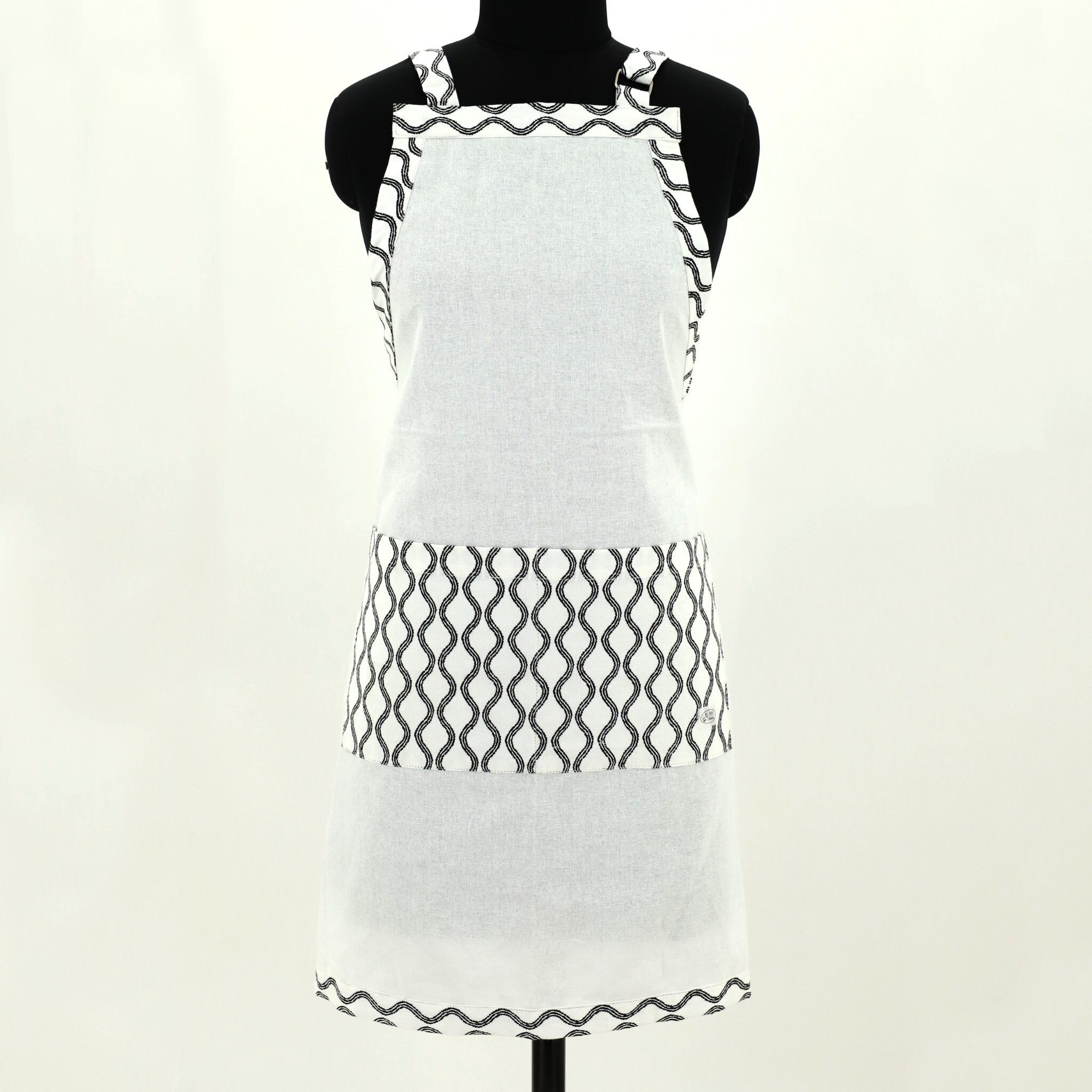 White apron with black steam pattern on a mannequin against a white background
