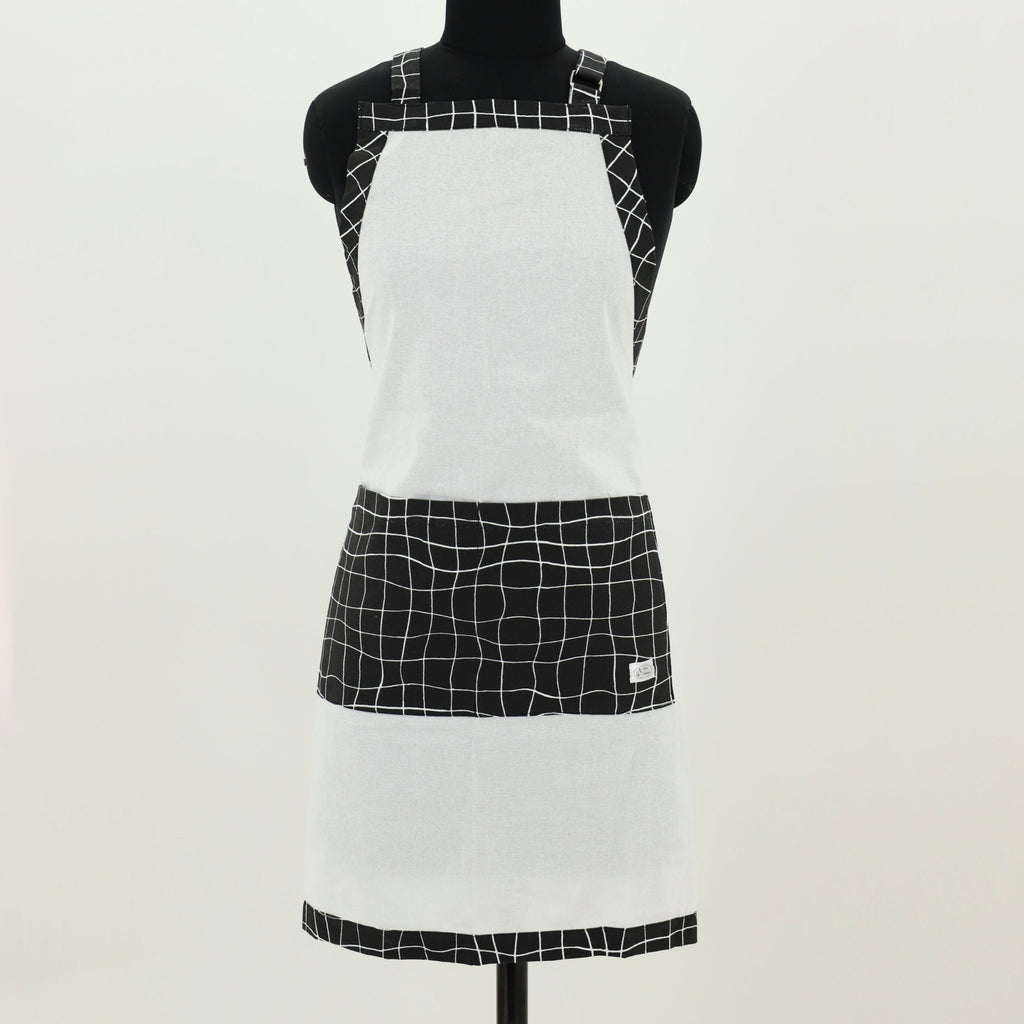White apron with black string grid pattern on a mannequin against a white background