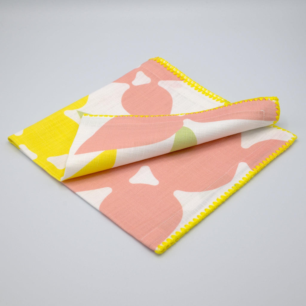 Blush and Yellow Pure Cotton Dinner Napkin 'Celebration' design by Hem And Tassel on a gray background
