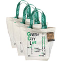 Set of three white tote bags with green handles and text on a white background from Hem And Tassel 