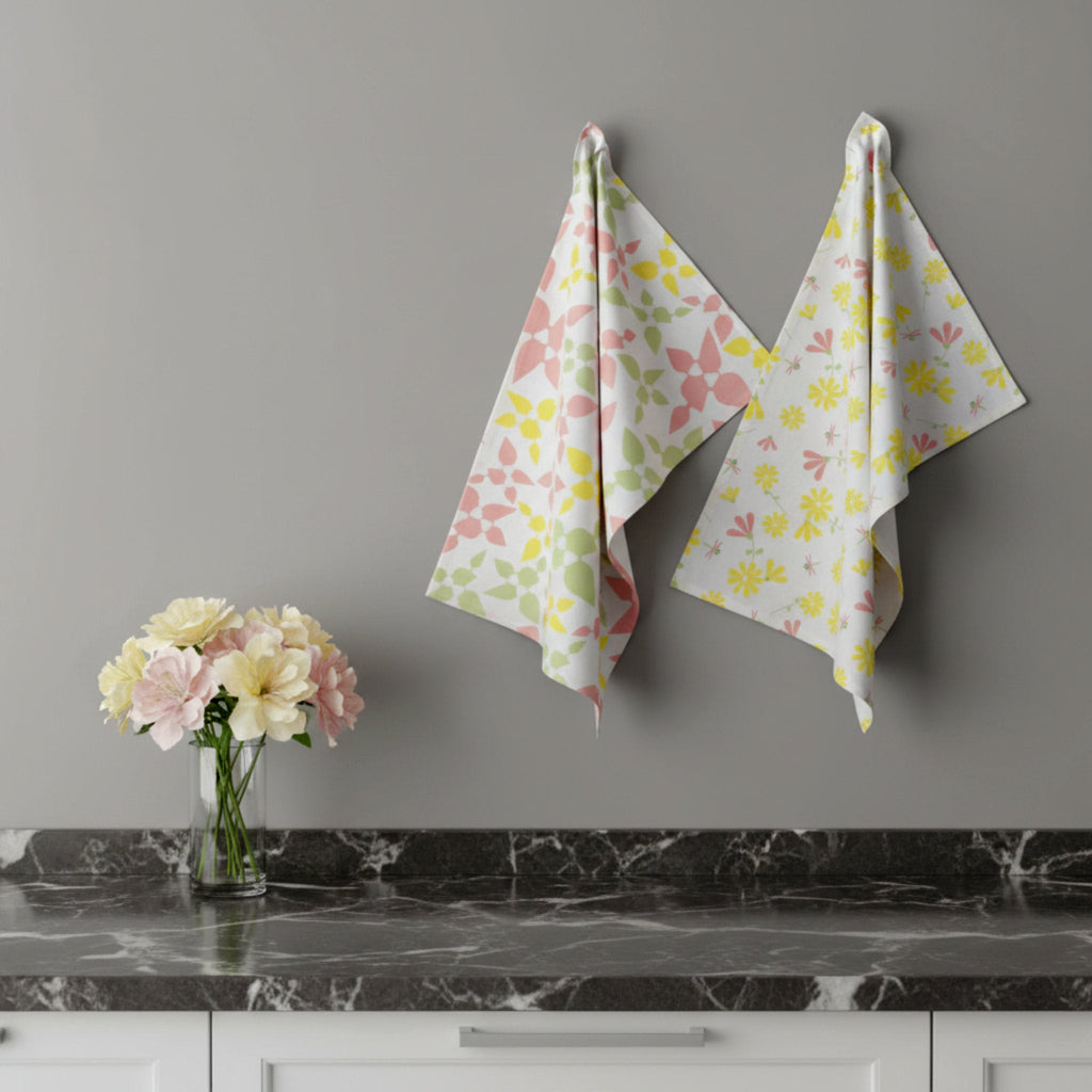 Floral-patterned cotton kitchen towels  hanging on a gray wall with a vase of flowers on a marble countertop from Hem And Tassel
