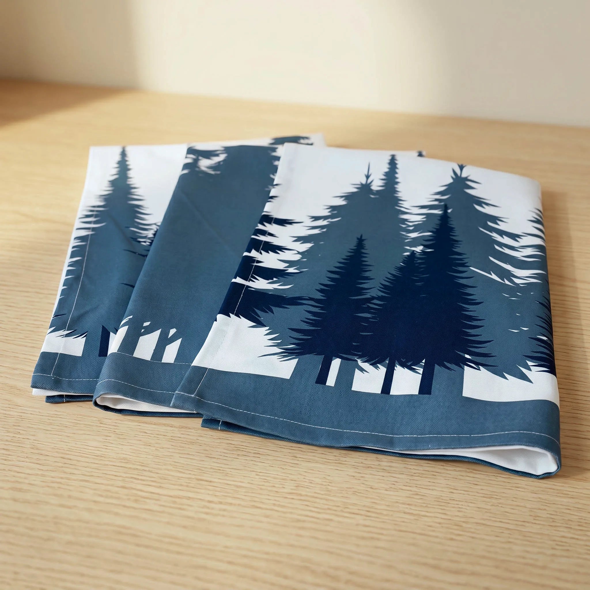 Folded cotton kitchen towels set of 3 with trees pattern on a wooden surface from Hem And Tassel