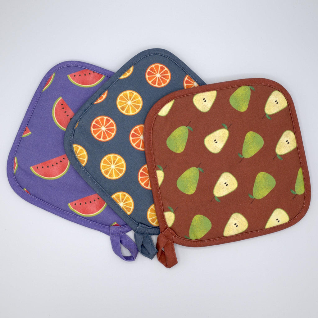 Three pot holders with faded fruit patterns on a white background from Hem And Tassel 