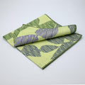 Mint and green Pure Cotton Dinner Napkin 'Celebration' design by Hem And Tassel on a light gray background