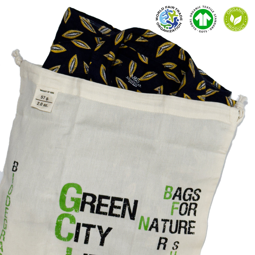 White drawstring bag with 'Green City' text, containing a black shirt on a white background from Hem And Tassel 