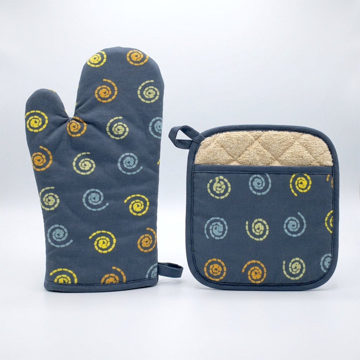 A matching kitchen set featuring a oil blue oven mitt and a square pot holder with a yellow, orange, and blue spiral pattern, both with beige sherpa lining, set against a light gray background from Hem And Tassel 
