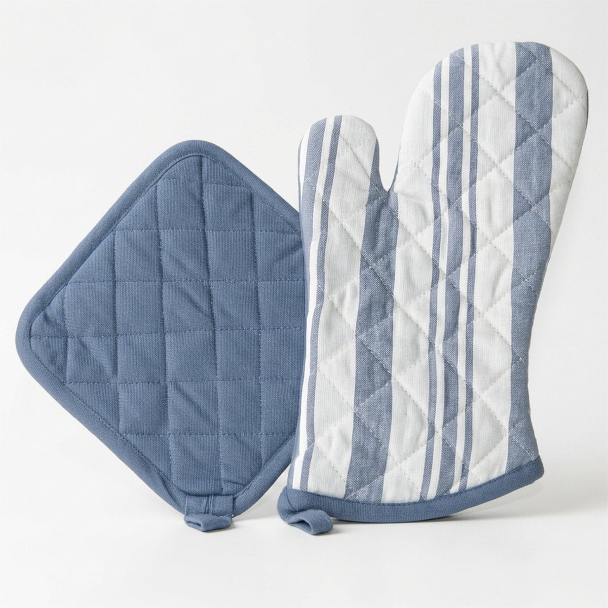 A quilted kitchen set featuring a blue pot holder and a matching oven mitt with vertical blue and white stripes, displayed on a clean white background from Hem And Tassel 