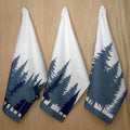 three kitchen towels in rich cotton percale with the park design hanging on a wood background