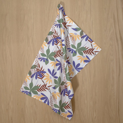 Fall colors in pollen up design tea towels hanging on a wooden backdrop
