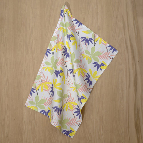 spring colors in pollen up design tea towels hanging on a wooden backdrop