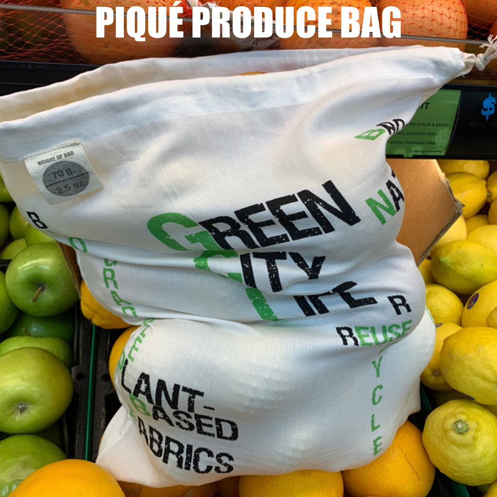 White piqué produce bag with text on a background of fruits and vegetables from Hem And Tassel 