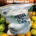 White piqué produce bag with text on a background of fruits and vegetables from Hem And Tassel 