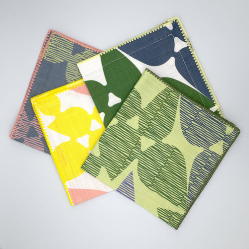 Set of four colorful Pure Cotton Dinner Napkins 'Celebration' design by Hem And Tassel on a light gray background