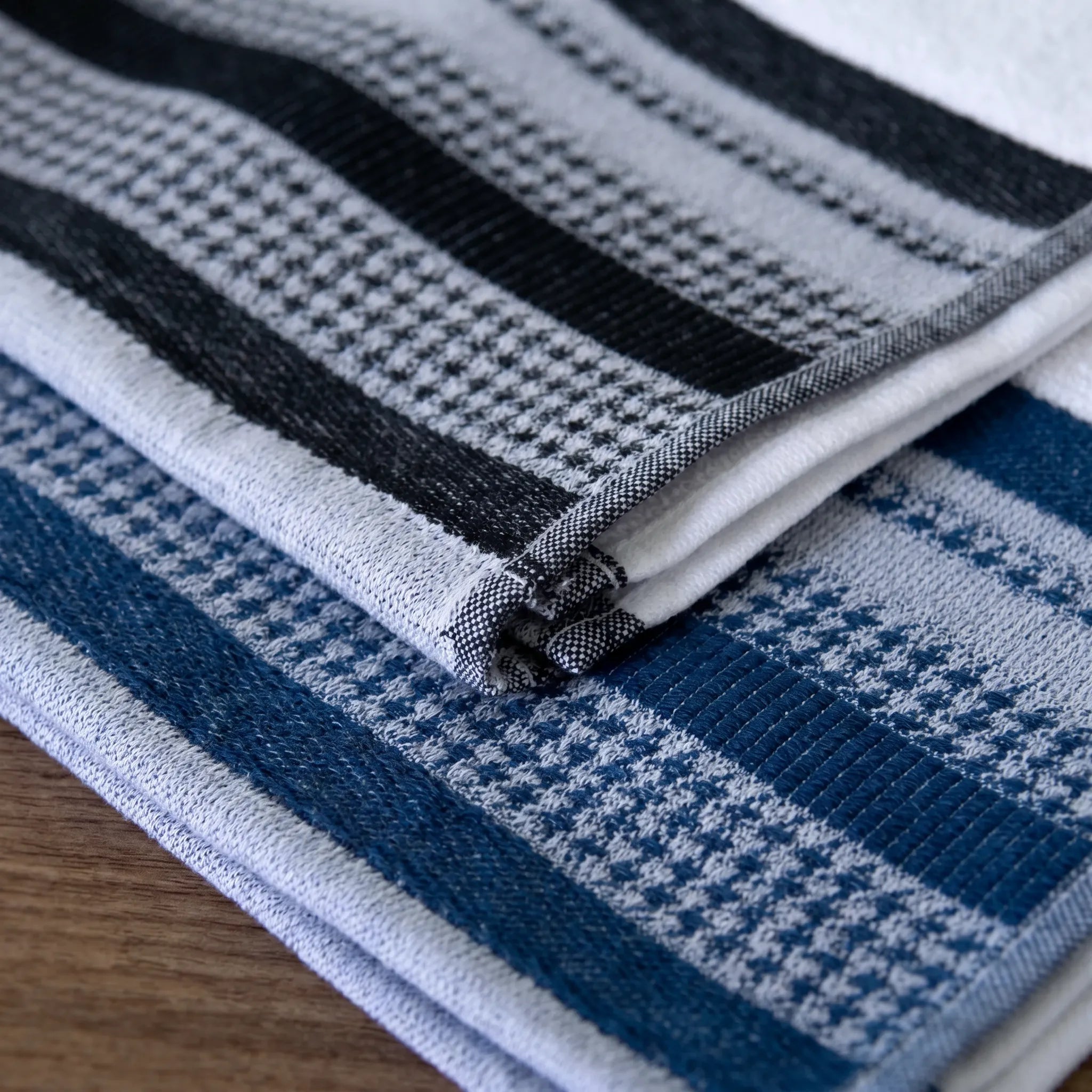 close up of luxurious deep pile Terry kitchen towels of 100% cotton - with houndstooth border one in blue and one in black, from Hem And Tassel 