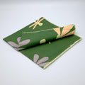 slub-cotton dinner napkin of shy dragonfly design in green against light grey backdrop- from Hem And Tassel