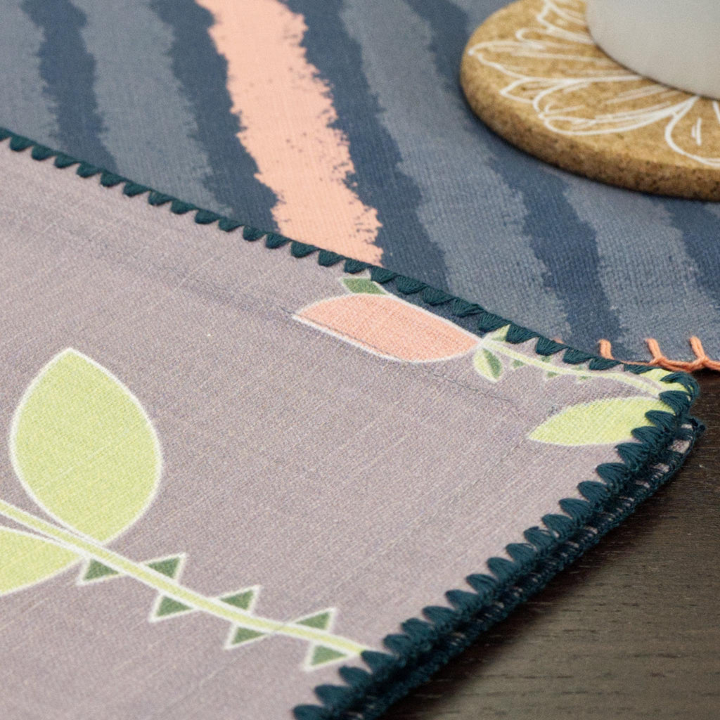 Close-up of a decorative edging of art deco lip tulip dinner napkin on a wooden surface.