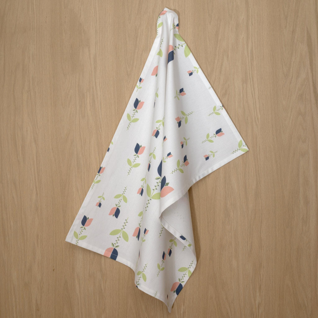 art deco lip tulip kitchen towel in oil and blush colors on a wooden surface from Hem And Tassel 