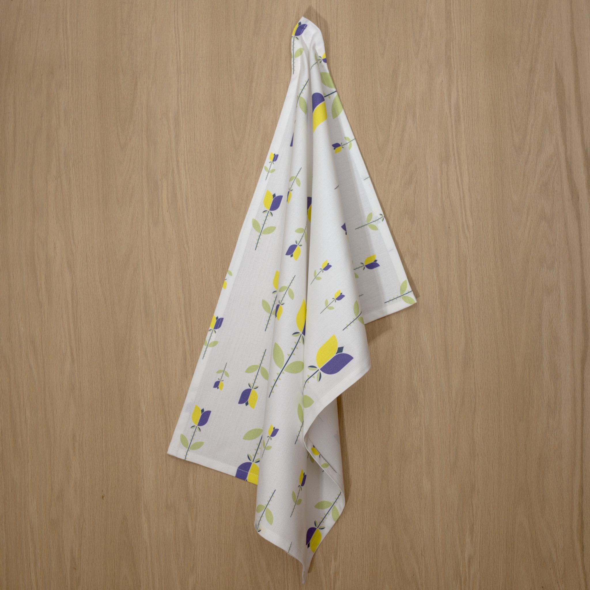 rich cotton percale kitchen towel of Lip Tulip design in yellow color on wooden background- from Hem And Tassel