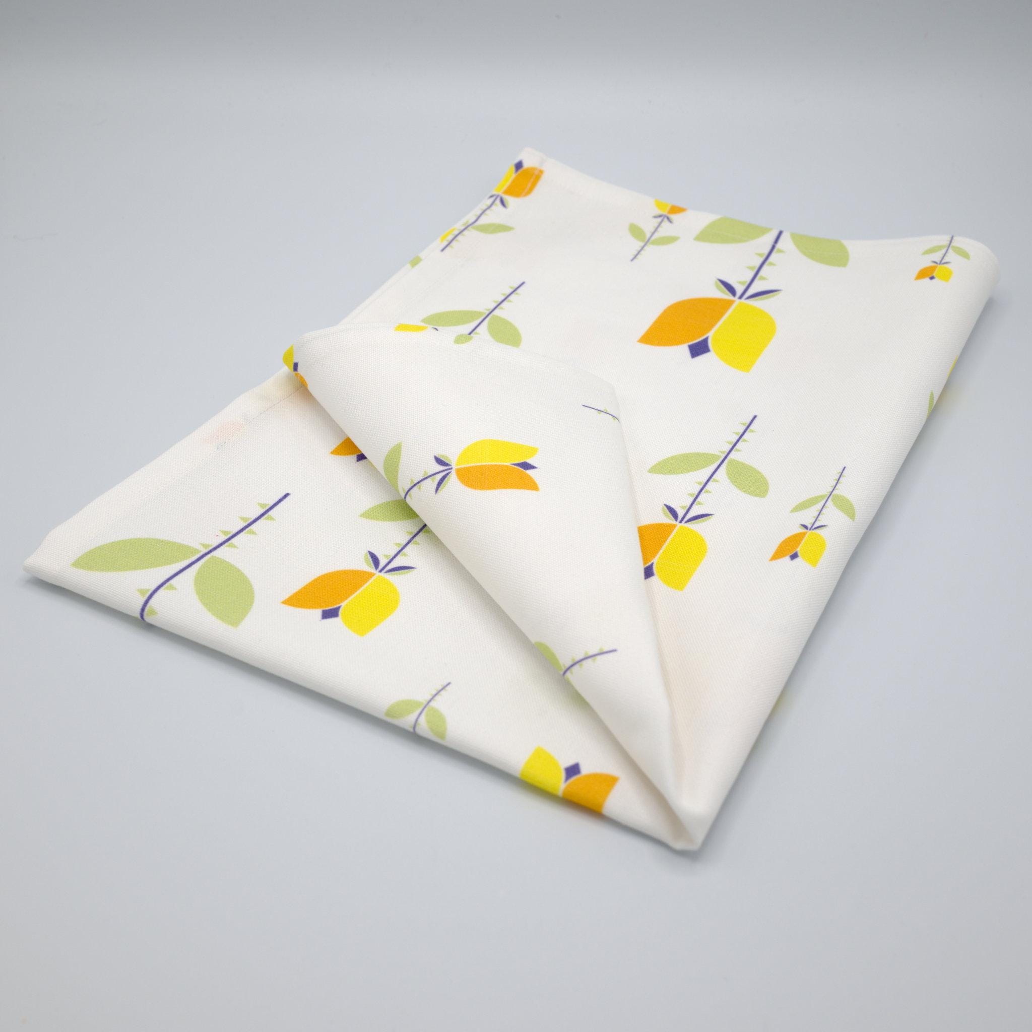 art deco lip tulip kitchen towel with a yellow and orange floral pattern on a gray background from Hem And Tassel 