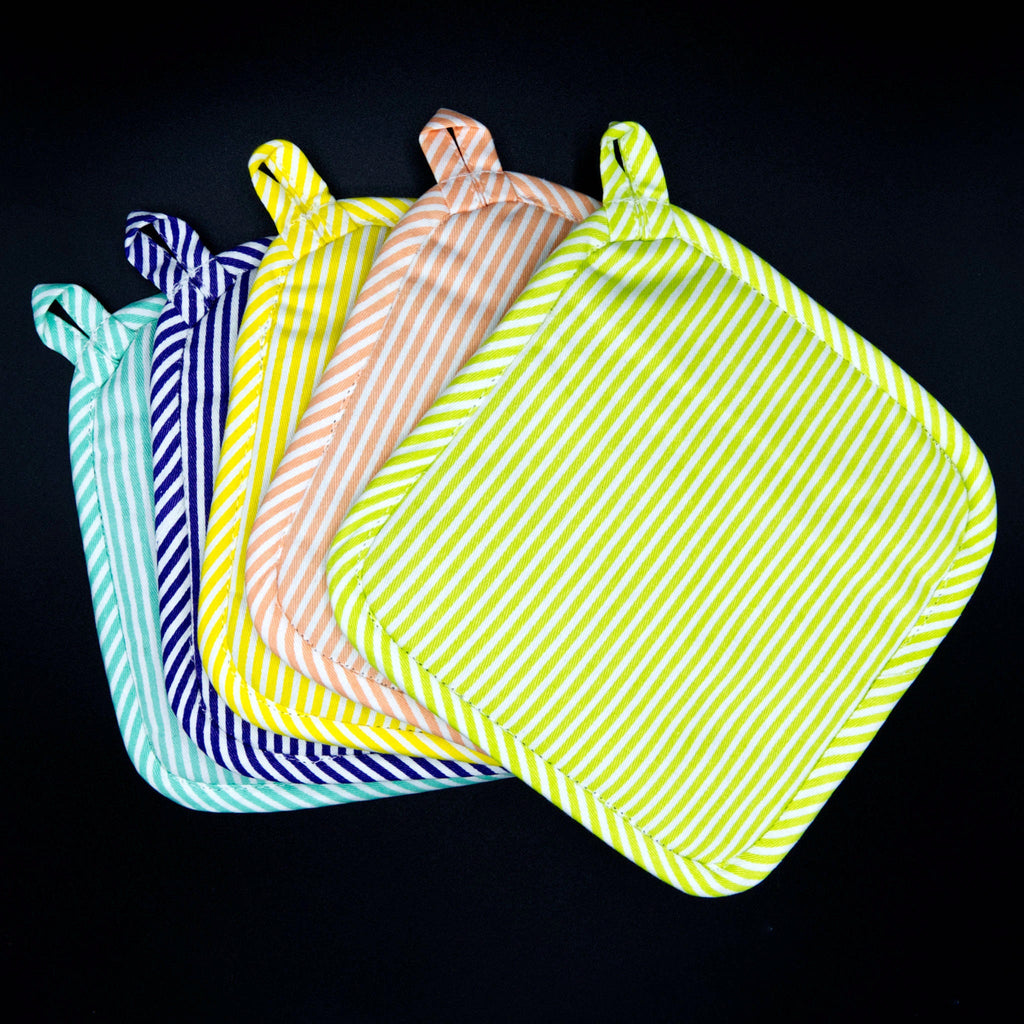 Set of colorful banker stripes pot holders on a black background from hem and tassel