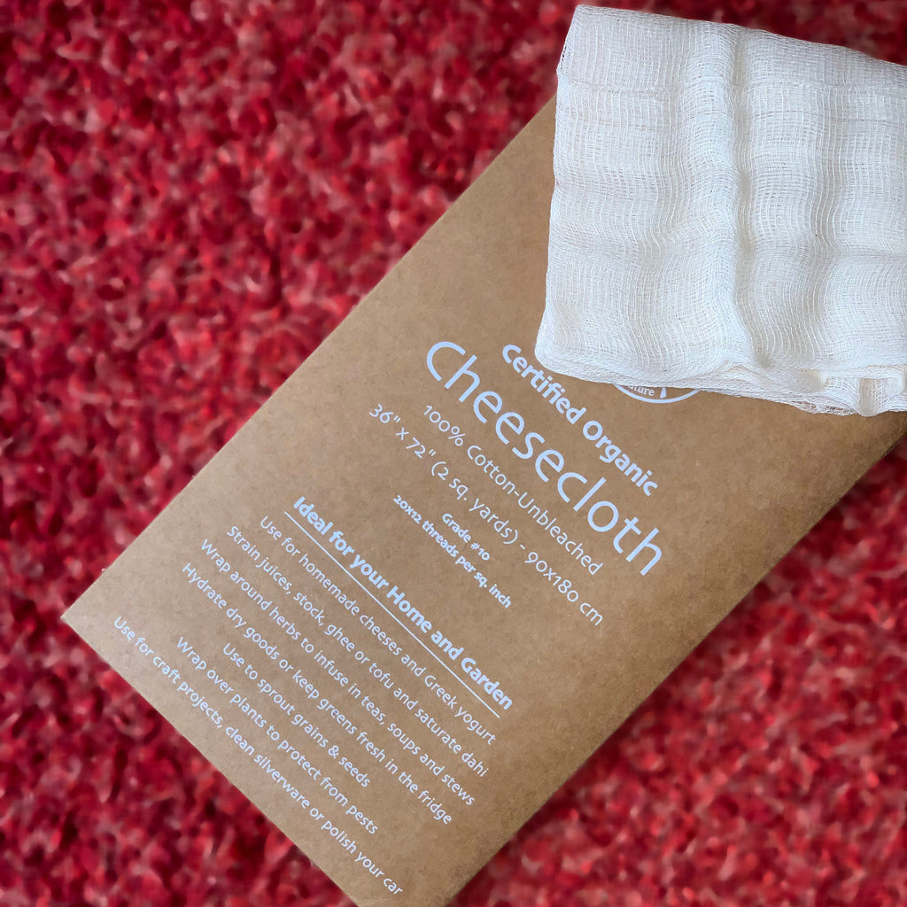 Certified Organic Cheesecloth package with white cheesecloth on a red textured background from Hem And Tassel 