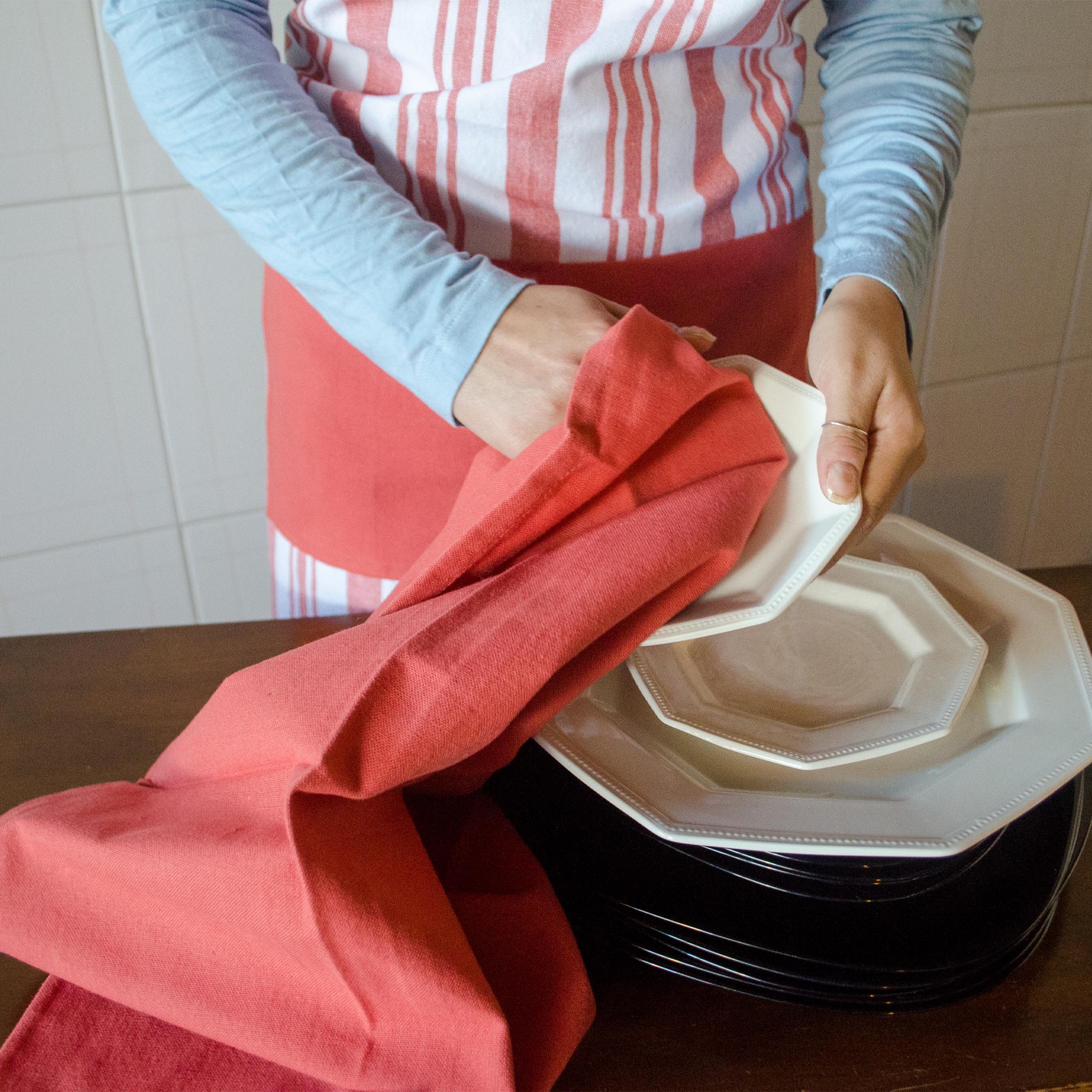 cotton decade classic striped Apon in red from Hem And Tassel on person wiping dish with everyday classic red kitchen towel