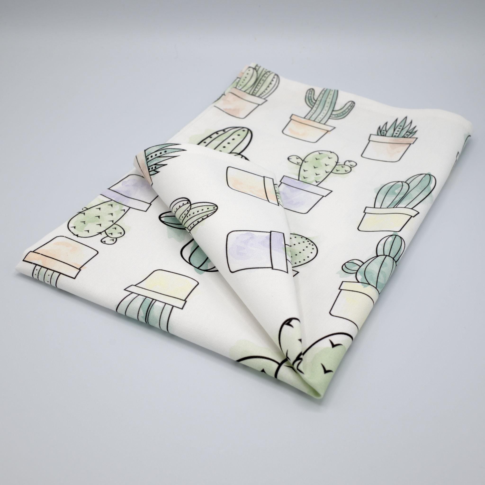 desert haze tea towel with cactus pattern on a light gray background from Hem And Tassel