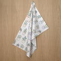 rich cotton percale tea towel of desert haze design hanging on a wooden background - from Hem And Tassel