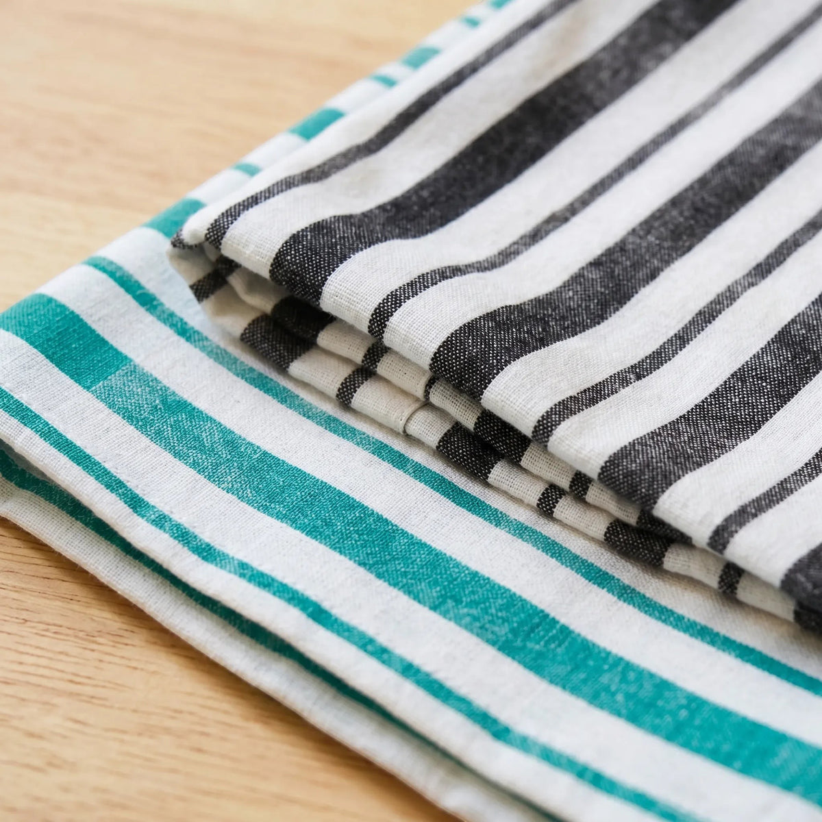 distressed strips kitchen towels of 100% cotton in a set of two - one charcoal and one green, close up from Hem And Tassel