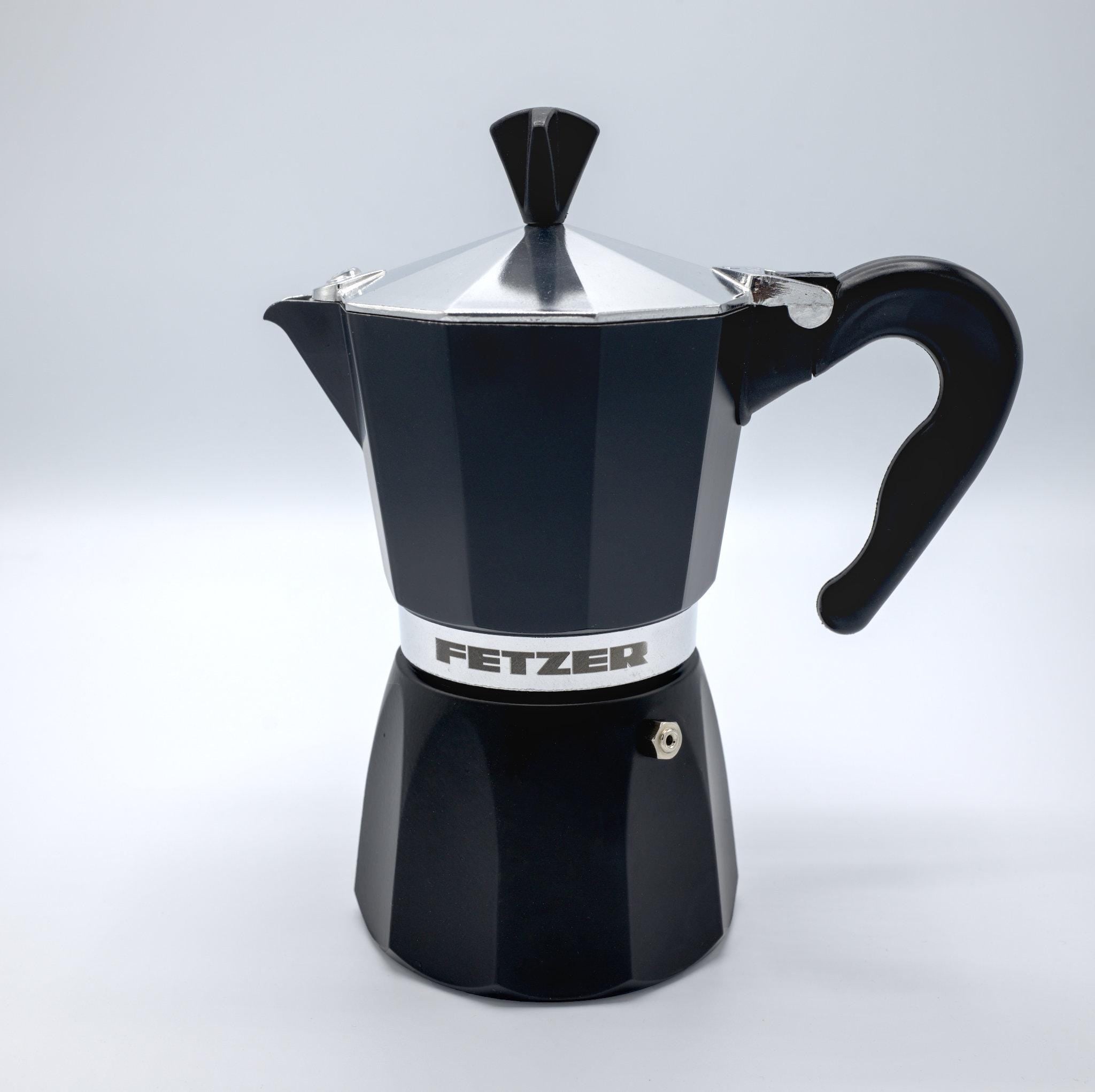 made in italy black dolce moka pot with fether logo on it from Hem And Tassel against a light grey background