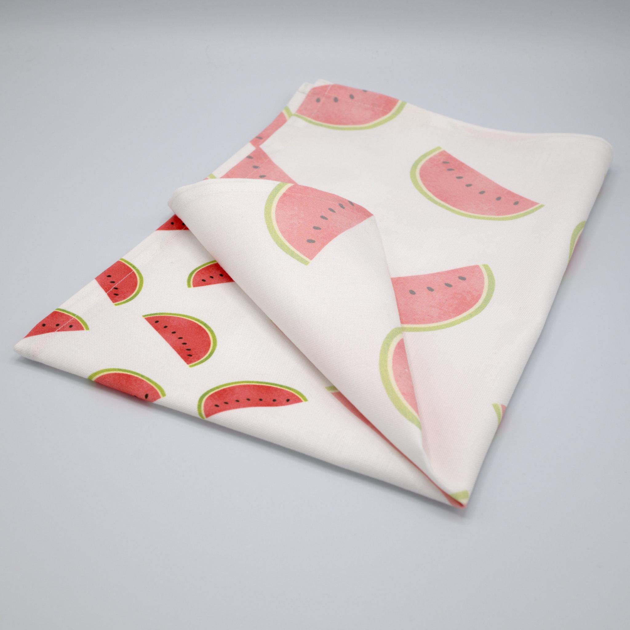 faded fruit kitchen towel folded with watermelon pattern on a gray background from Hem And Tassel 