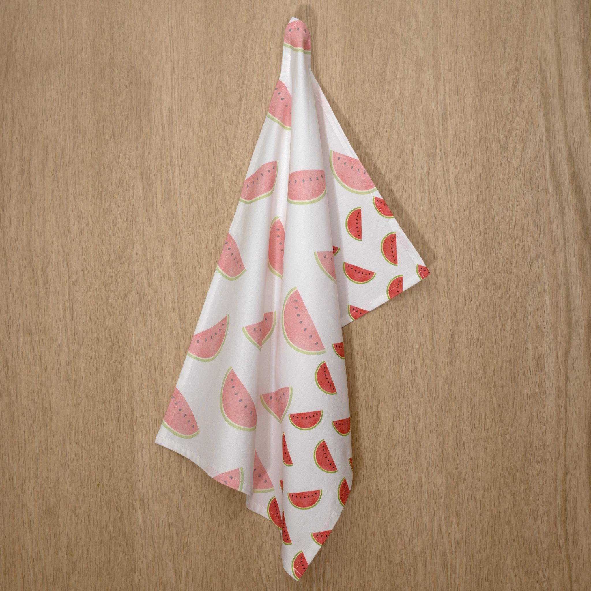 rich cotton percale kitchen towel in faded melon design hanging on wooden background- from Hem And Tassel