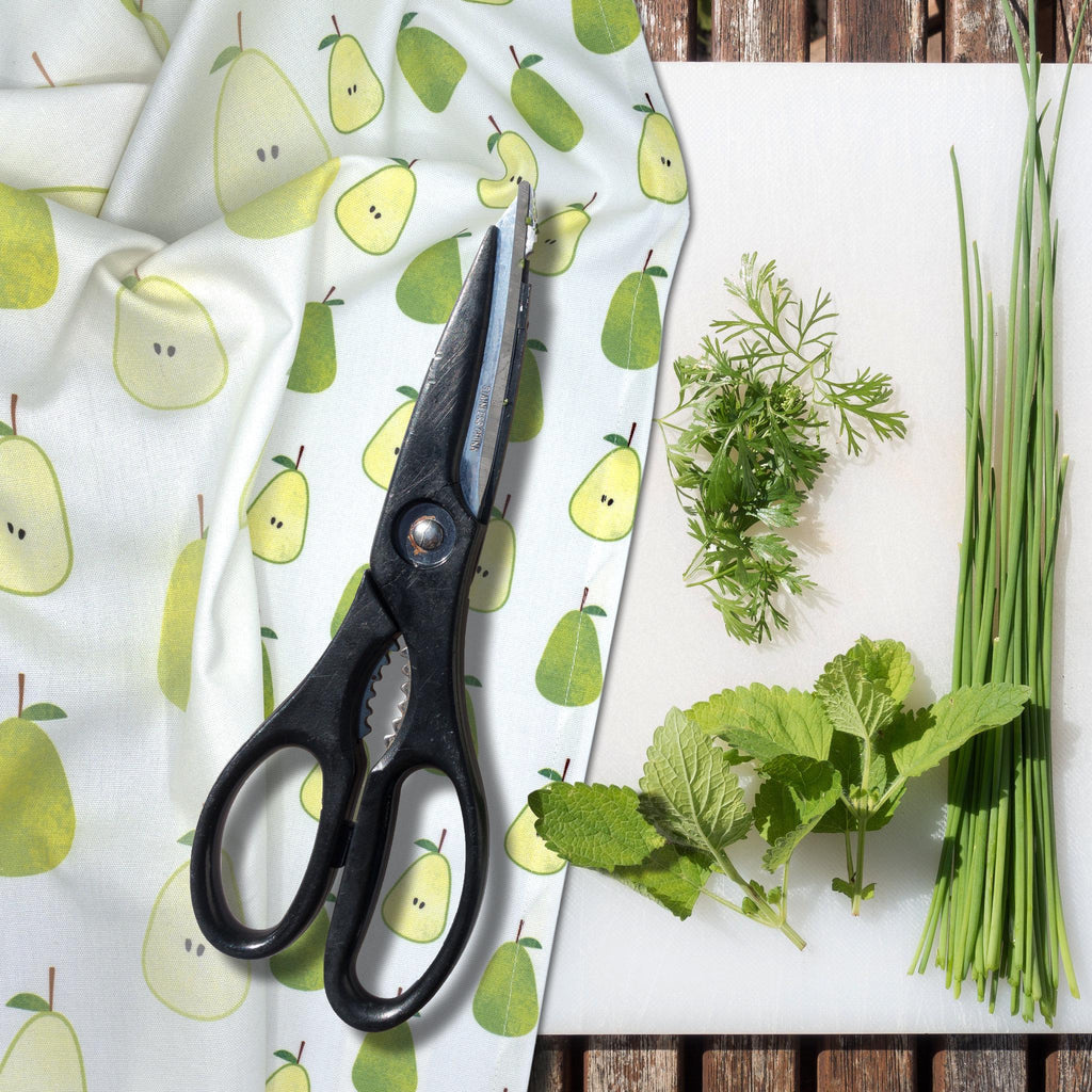 rich cotton percale kitchen towel in faded pear design on kitchen cutting board with herb-scissors and herbs - from Hem And Tassel