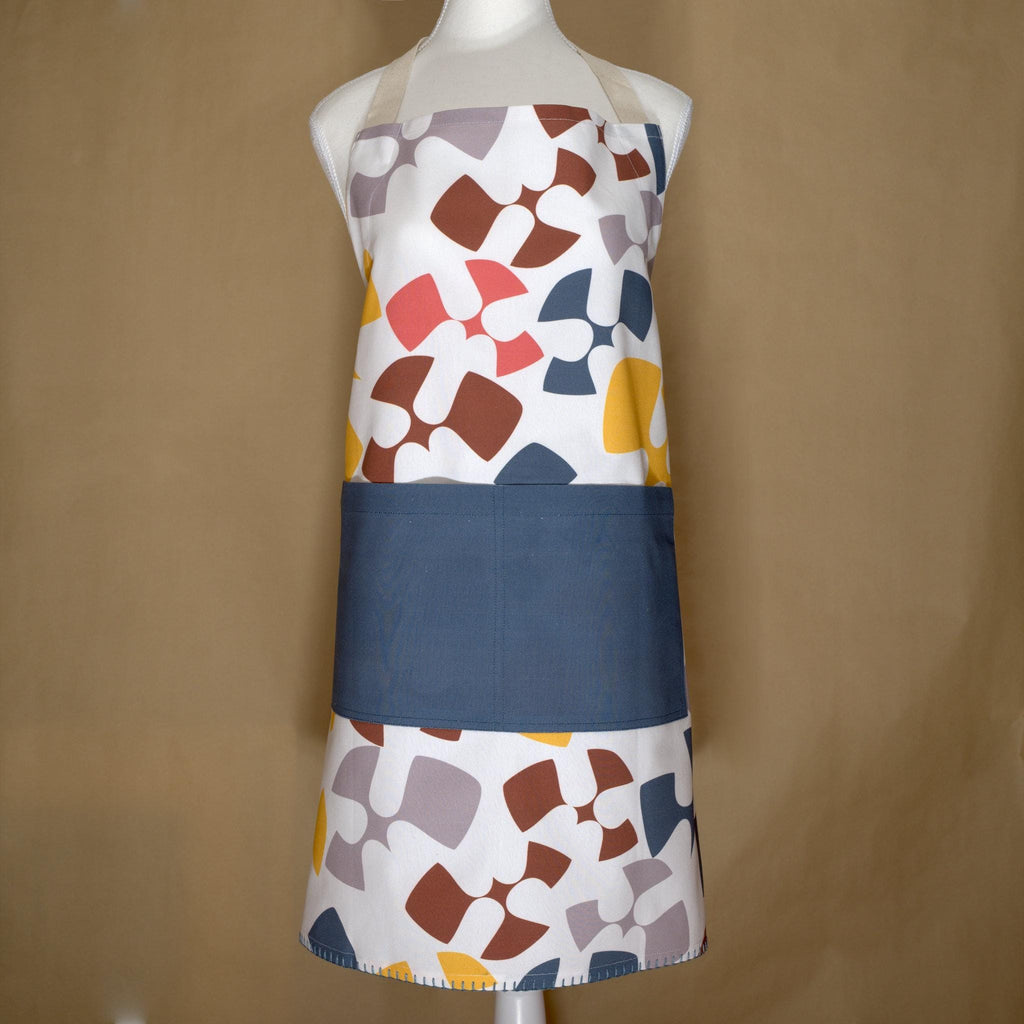 Mannequin wearing Colorful flock and flutter patterned cotton apron with a oil color pocket from Hem And Tassel, on a beige background