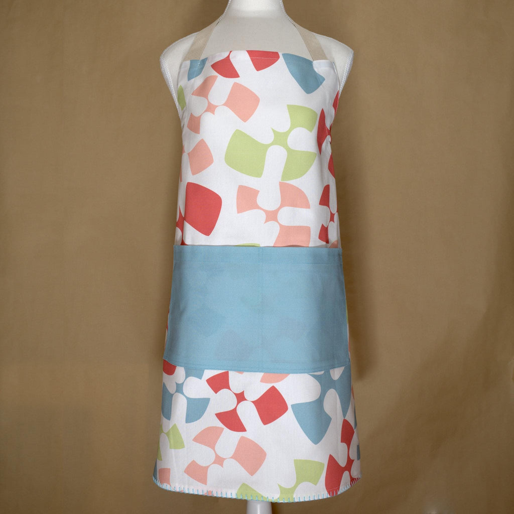 mannequin wearing Colorful flock and flutter patterned cotton apron with a turquoise pocket from Hem And Tassel, on a beige background