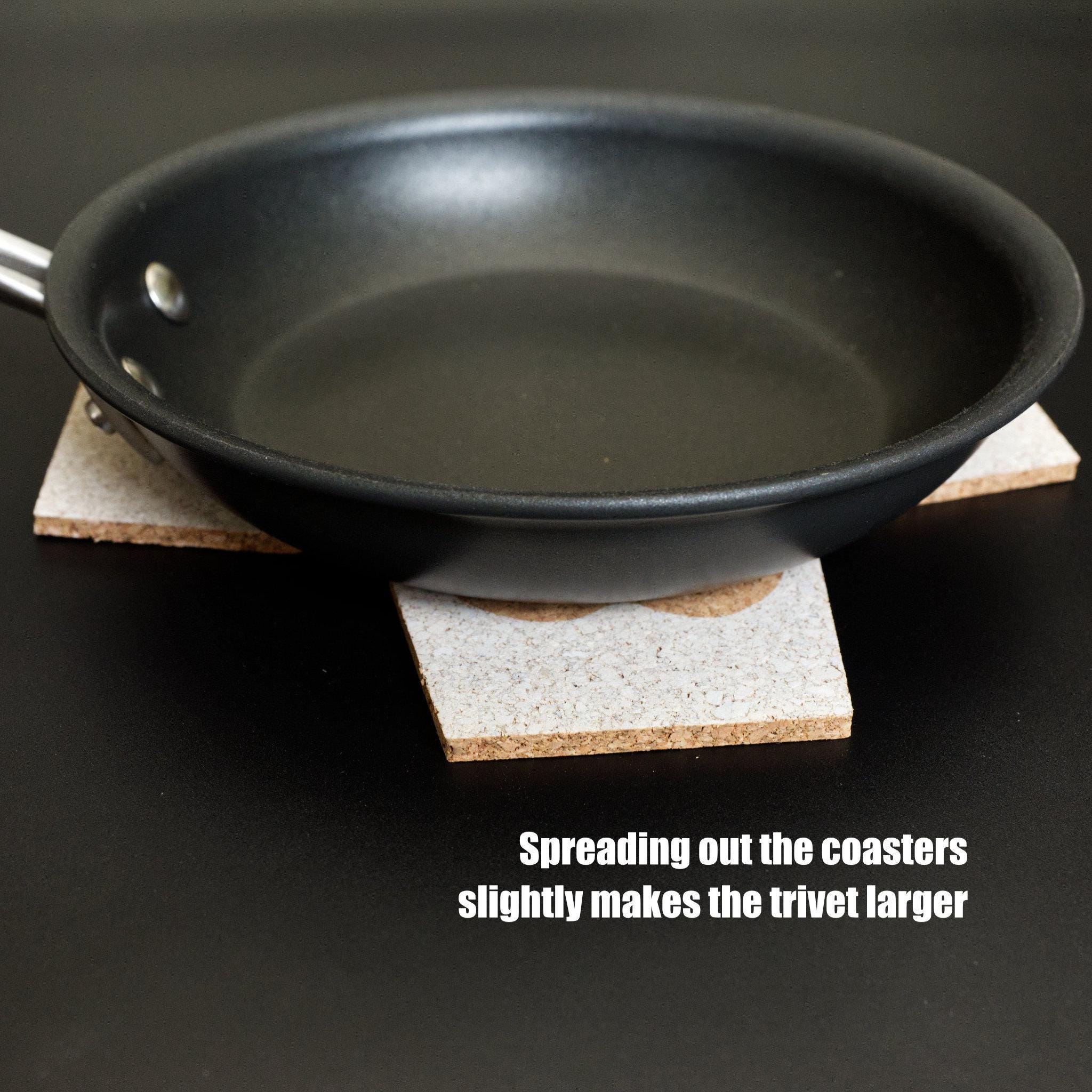 four heart clover cork coasters double up as trivet from Hem And Tassel with cooking pan on black background