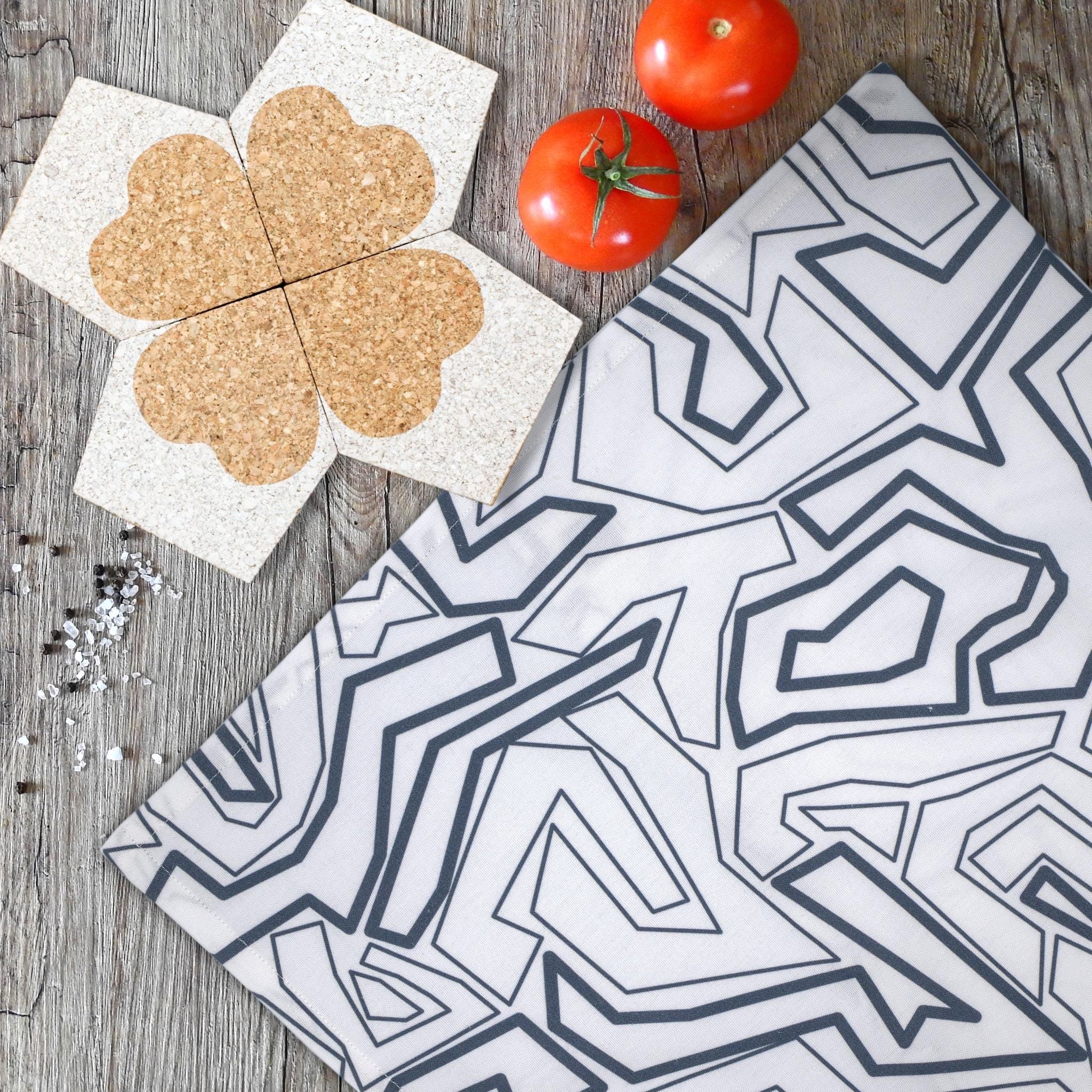 four heart clover cork coasters double up as trivet from Hem And Tassel with squiggles towel, tomatoes, salt and pepper on kitchen table