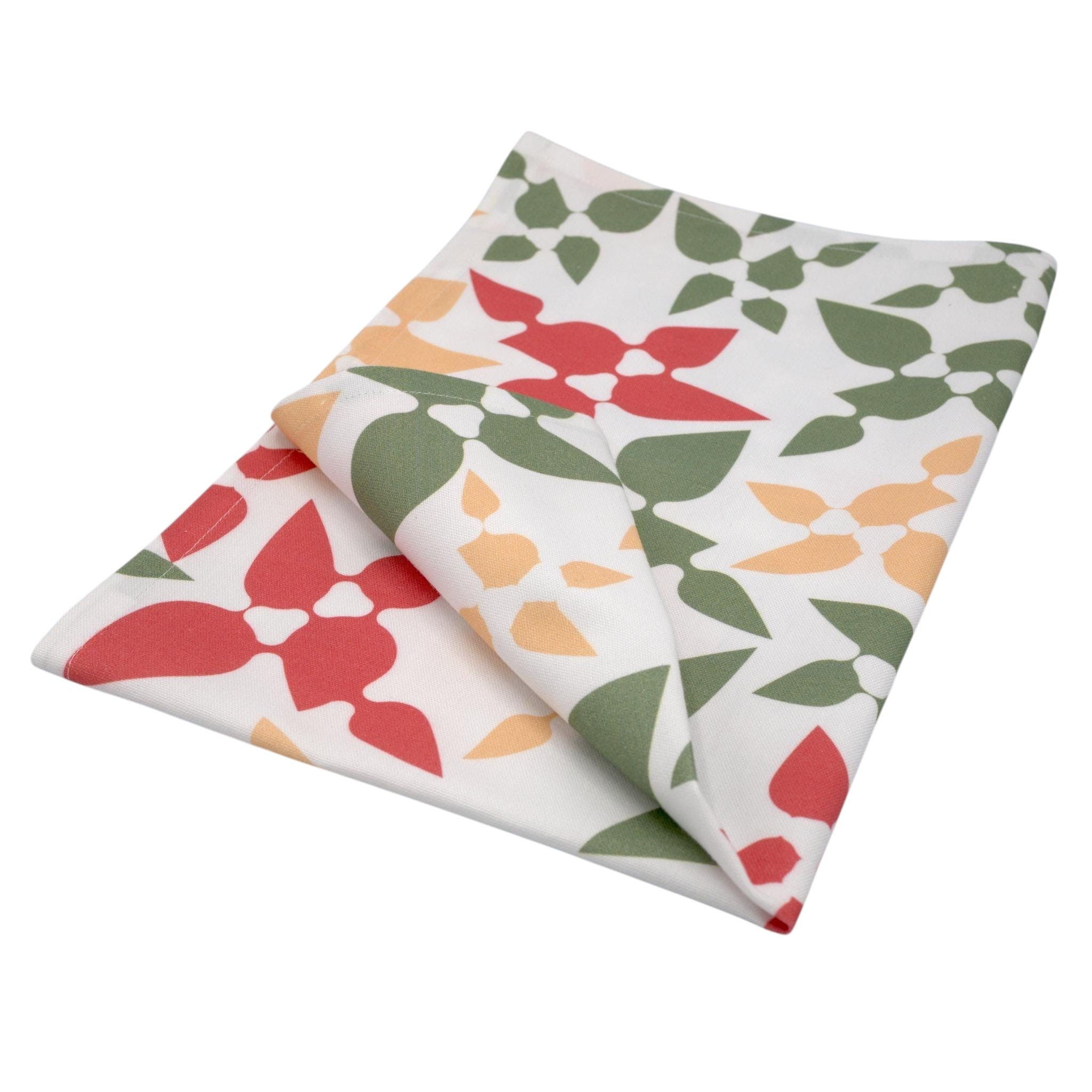 Hem And Tassel Celebration cotton kitchen towel with vibrant red, green, and yellow leaf confetti pattern on white