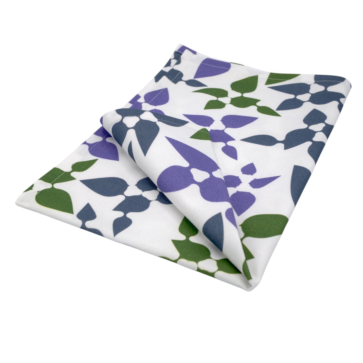 Hem And Tassel Celebration cotton kitchen towel with a white base and purple and green leaf confetti pattern.
