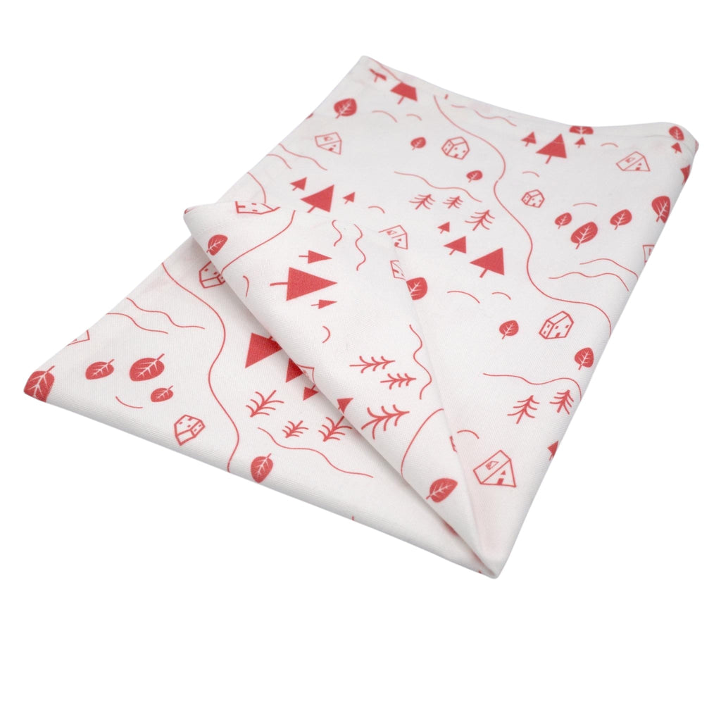 Hem And Tassel cotton kitchen towel featuring a red countryside print with trees, tents, and rivers on a white base.