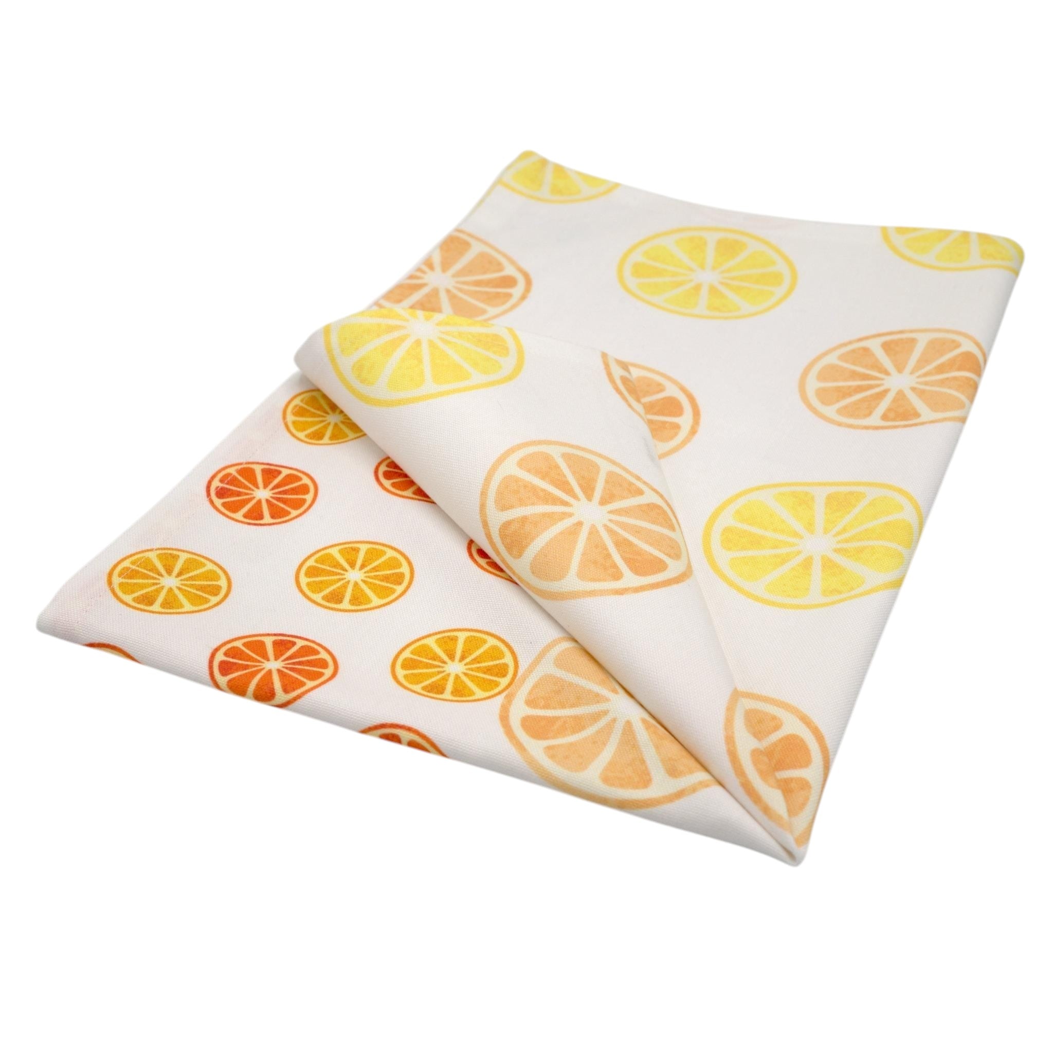 Hem And Tassel white cotton kitchen towel featuring a faded orange and lemon fruit slice pattern.
