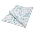 Hem And Tassel cotton kitchen towel with a modern blue and white geometric squiggles pattern on high-count fabric.