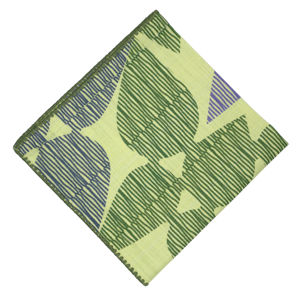 Hem And Tassel Celebration dinner napkin in green slub cotton with a leaf-inspired confetti pattern