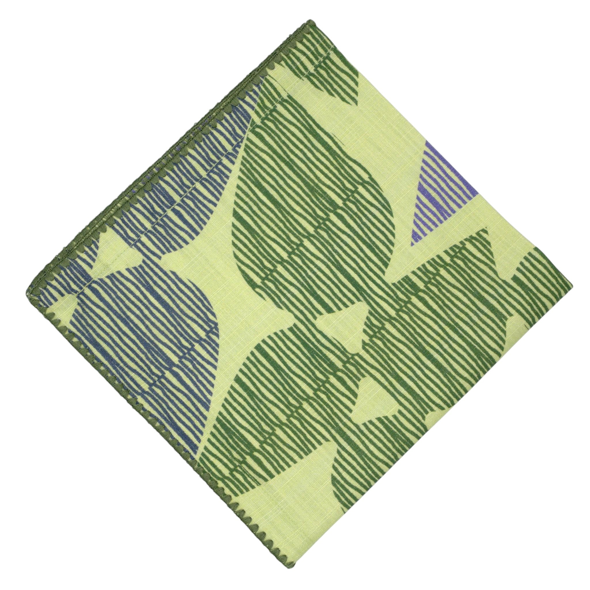 Hem And Tassel Celebration dinner napkin in green slub cotton with a leaf-inspired confetti pattern