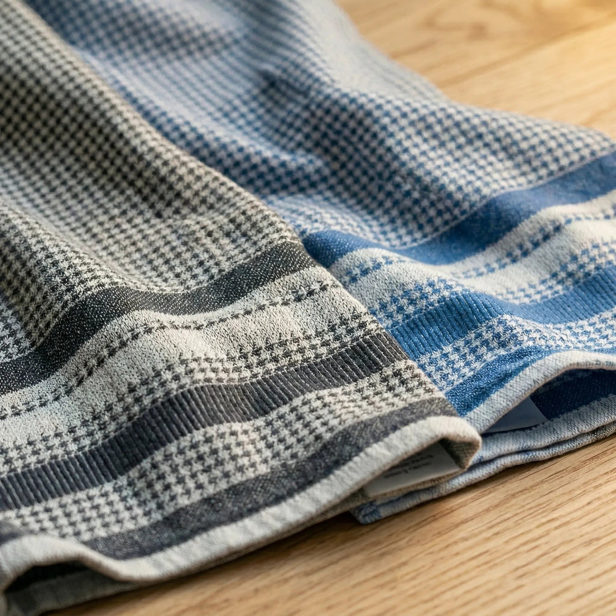 Hem And Tassel houndstooth cotton kitchen and bath towels in blue and grey, featuring plush and flat terry jacquard.
