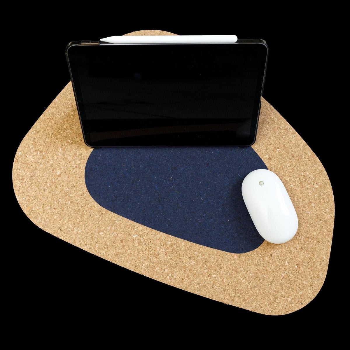 Hem And Tassel oversize kidney bean shaped cork placemat with a navy blue center inlay, holding a tablet and mouse.