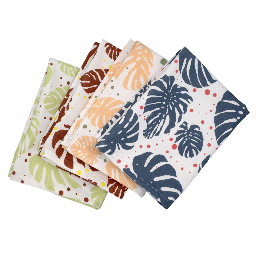 Hem And Tassel cotton kitchen towels featuring a colorful monstera leaf pattern on a white background