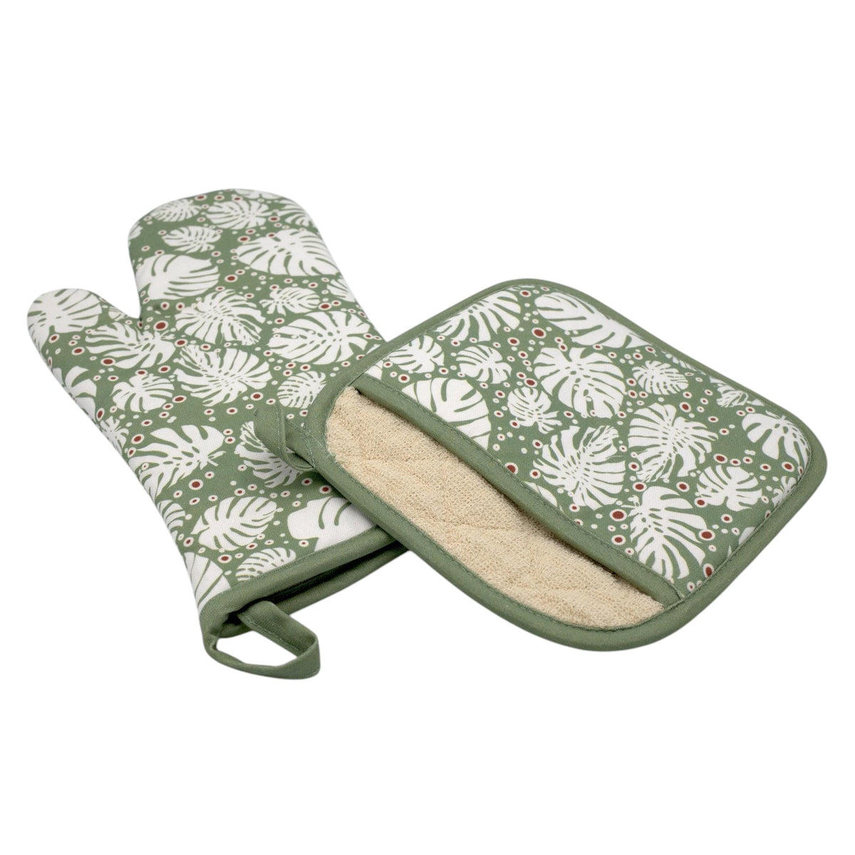 Hem And Tassel cotton oven mitt and pot holder set featuring a green and white tropical monstera leaf print