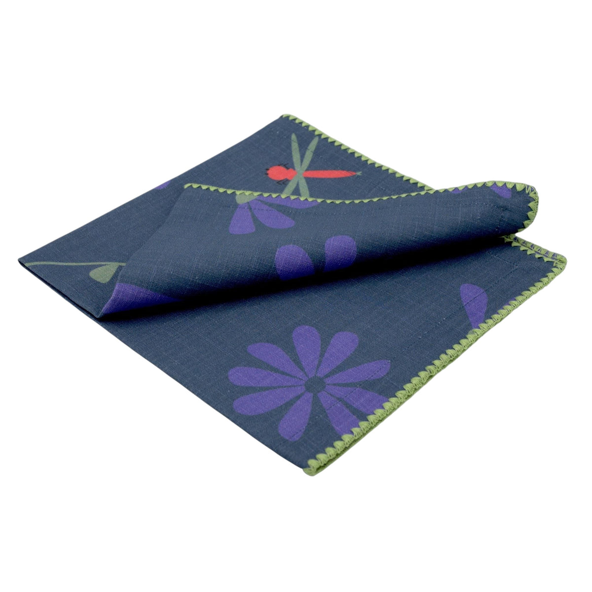 Hem And Tassel dinner napkin in dark grey slub cotton with purple floral and red dragonfly print and green trim.